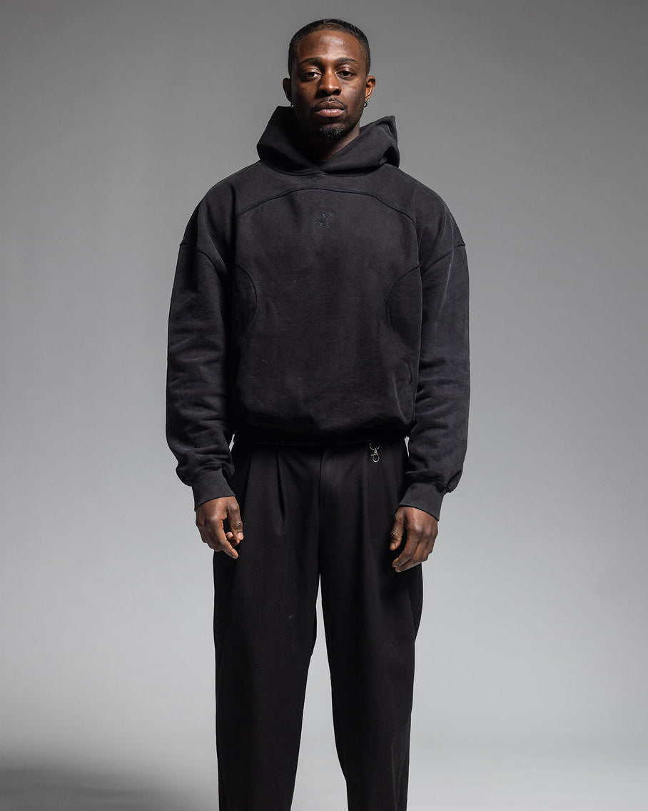 Man wearing Trew Collections Black on Black Hoodie Front Facing