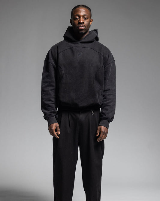 Man wearing Trew Collections Black on Black Hoodie Front Facing
